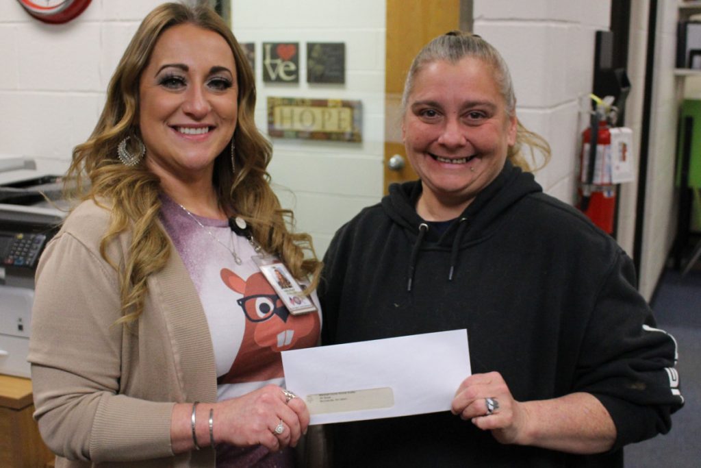From left: WLES Principal Julie Sturgill presents Marshall County Animal Shelter Dog Enrichment Specialist Mandy O’Neil with a monetary donation.